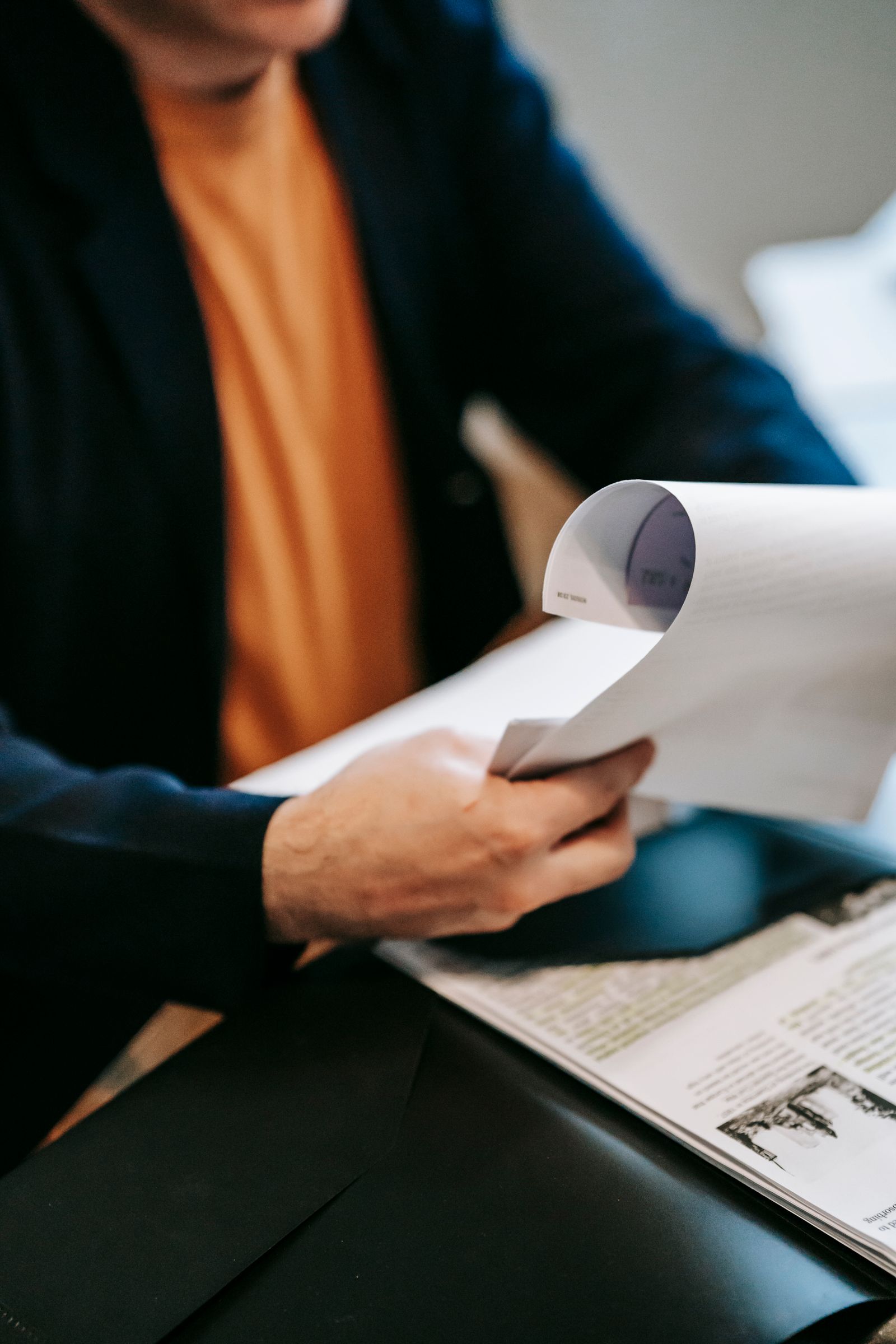 Hands reviewing printed documents at a desk